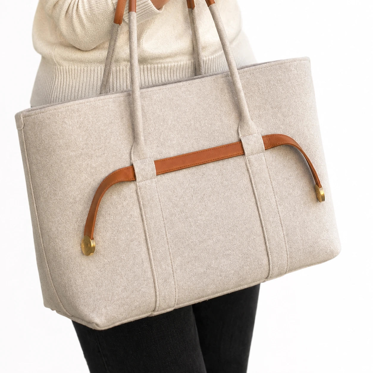The Colette Wool Tote in Caramel carried on the forearm