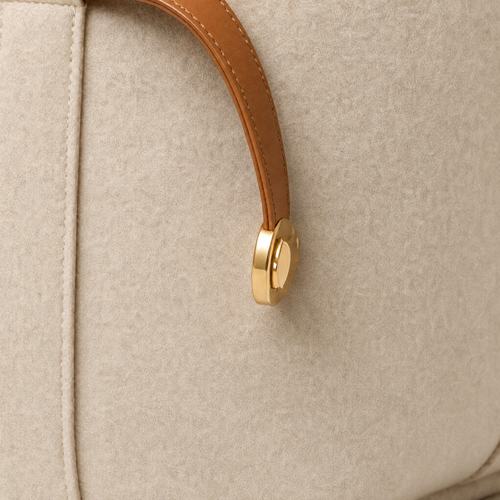 Detail of the Colette’s curved Caramel belt end and round gold-tone cap.