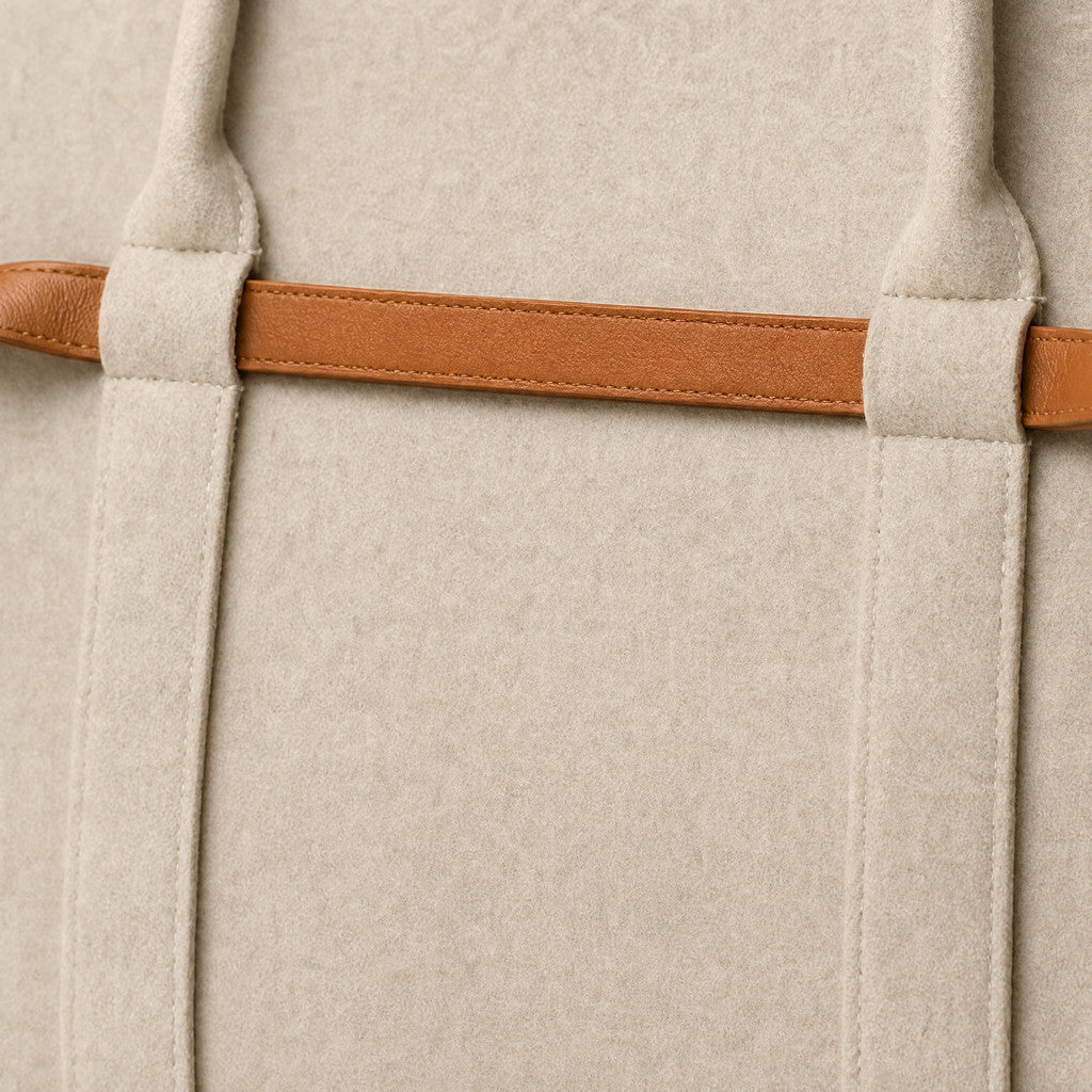 Detail of the Colette’s stitched Caramel belt passing through a felt keeper.
