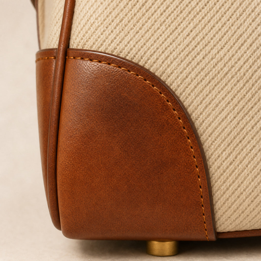 Close-up of the Delphine’s leather corner reinforcement and curved seam.