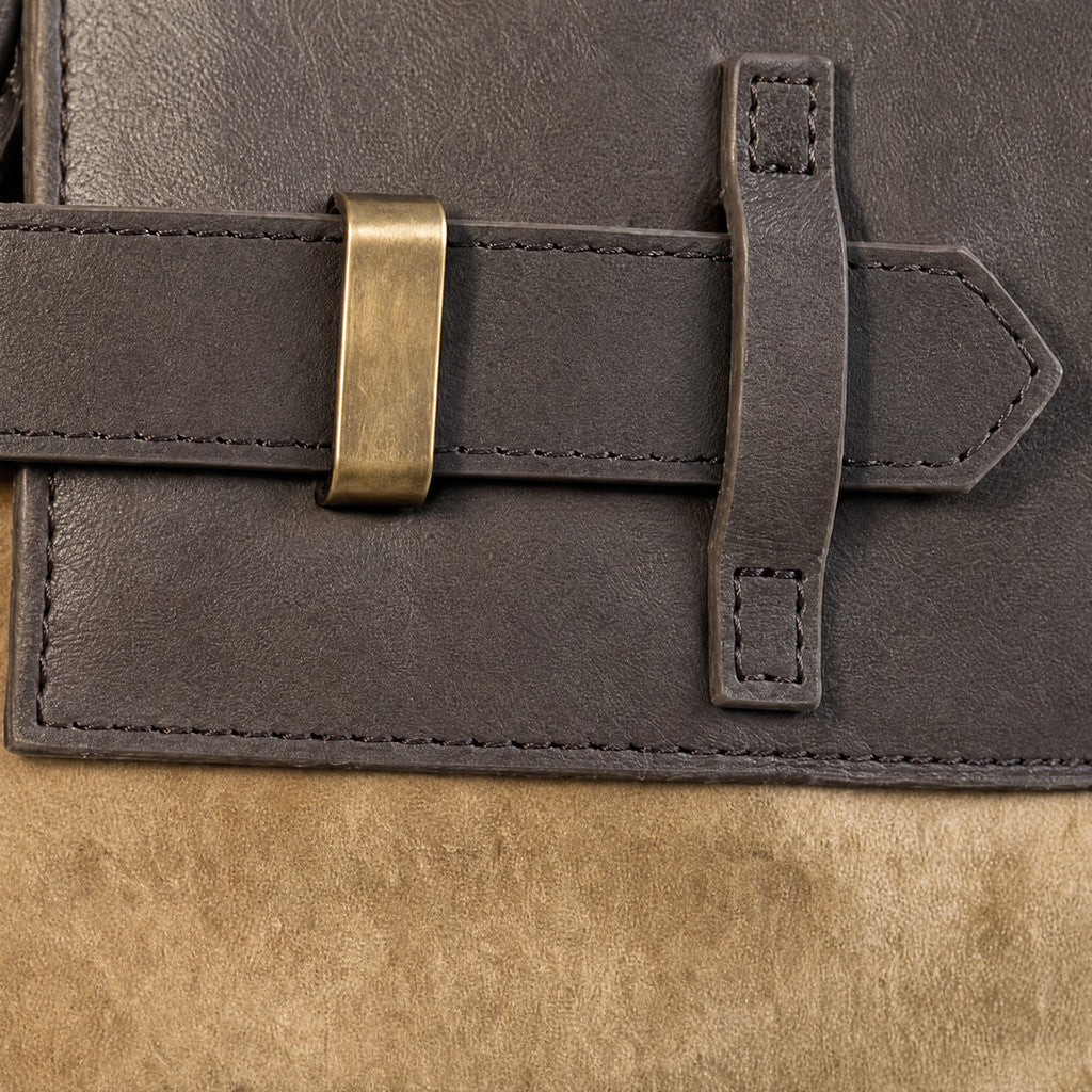 Detail of the Juliette’s antique-brass bar and dark leather front strap.