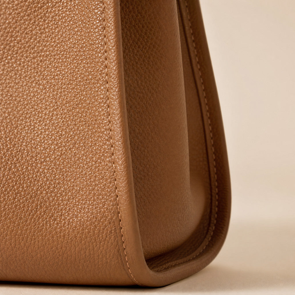 Close-up of the Meridian’s curved side gusset and finished leather edge.