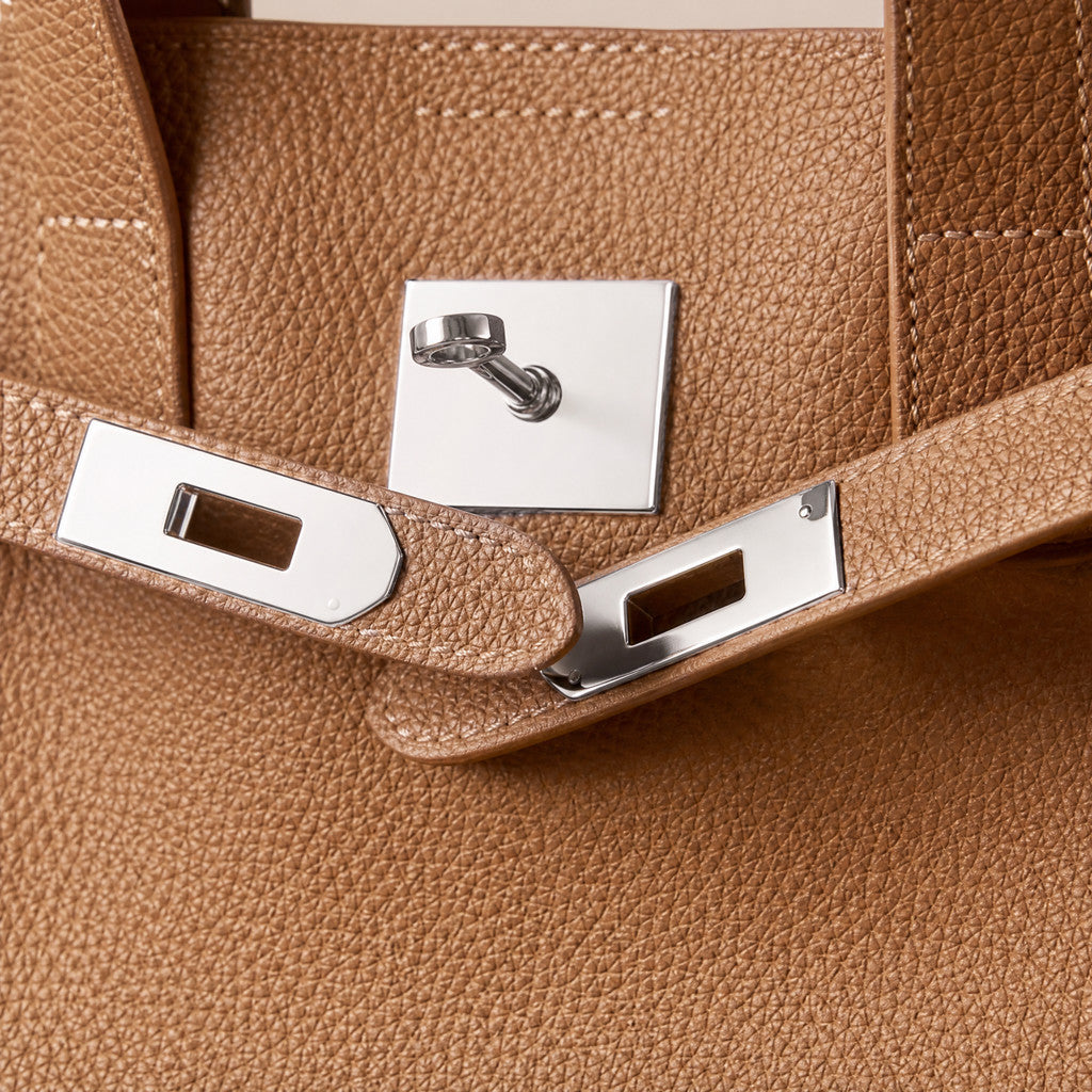 Detail of the Meridian’s silver center fitting and slotted belt ends.