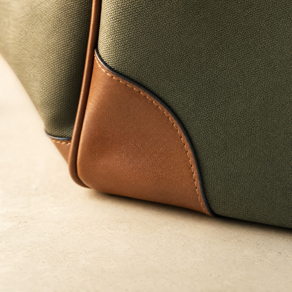Close-up of the Eleanor Weekender’s leather corner reinforcement and Army Green canvas.