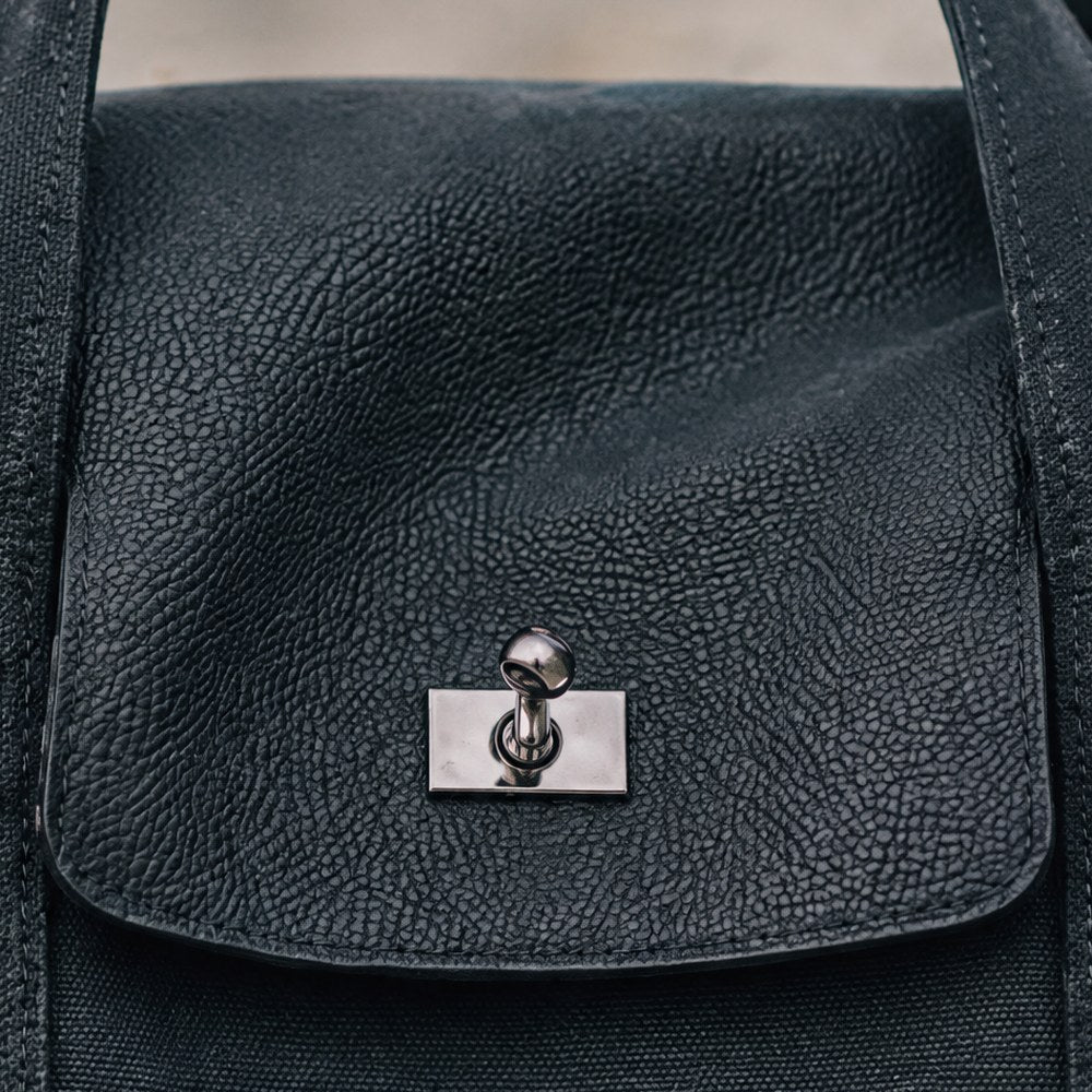 Close-up of the Lucienne's pebbled leather flap and turn-lock.