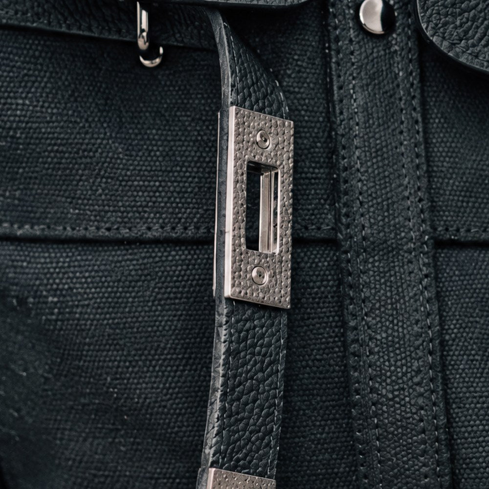 A leather drop strap on the Lucienne with its rectangular gunmetal plate.