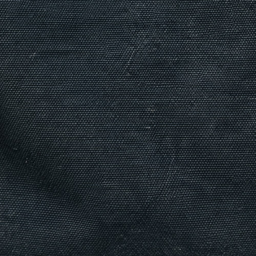 Close-up of the Lucienne's black waxed canvas weave.