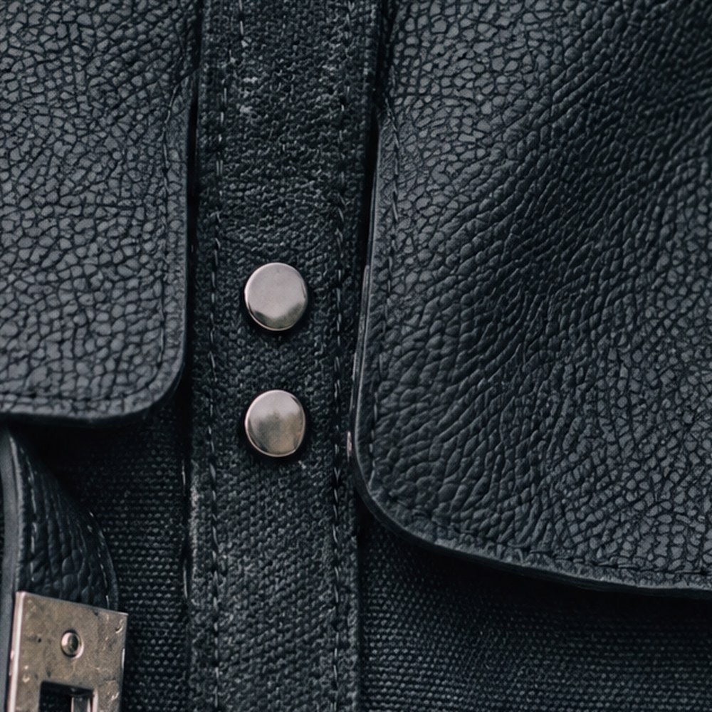 The Lucienne's canvas handle band with double topstitching and gunmetal rivets.