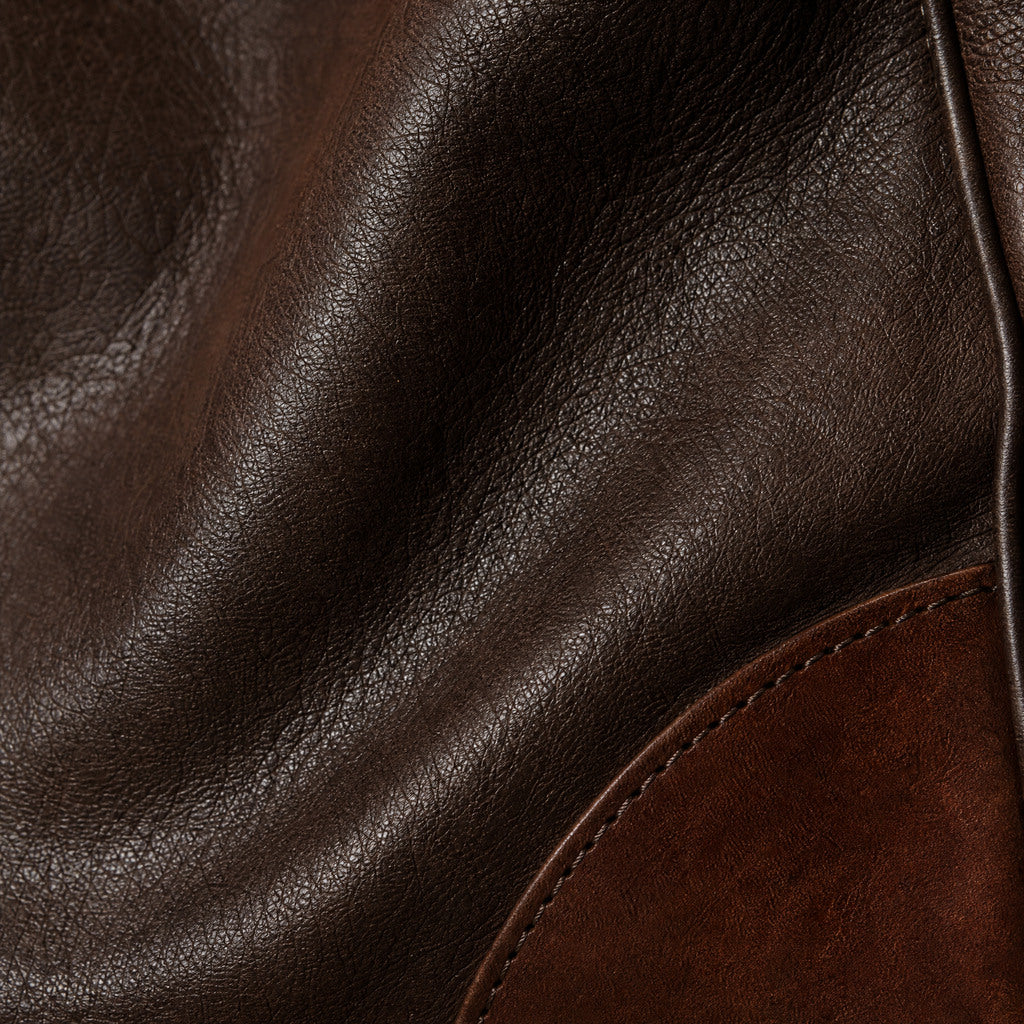 Close-up of the Vivienne’s Chocolate leather grain and contrasting corner trim.
